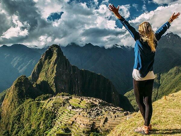 A tourist at the top of Machu Picchu Mountains near Sumaq Hotel