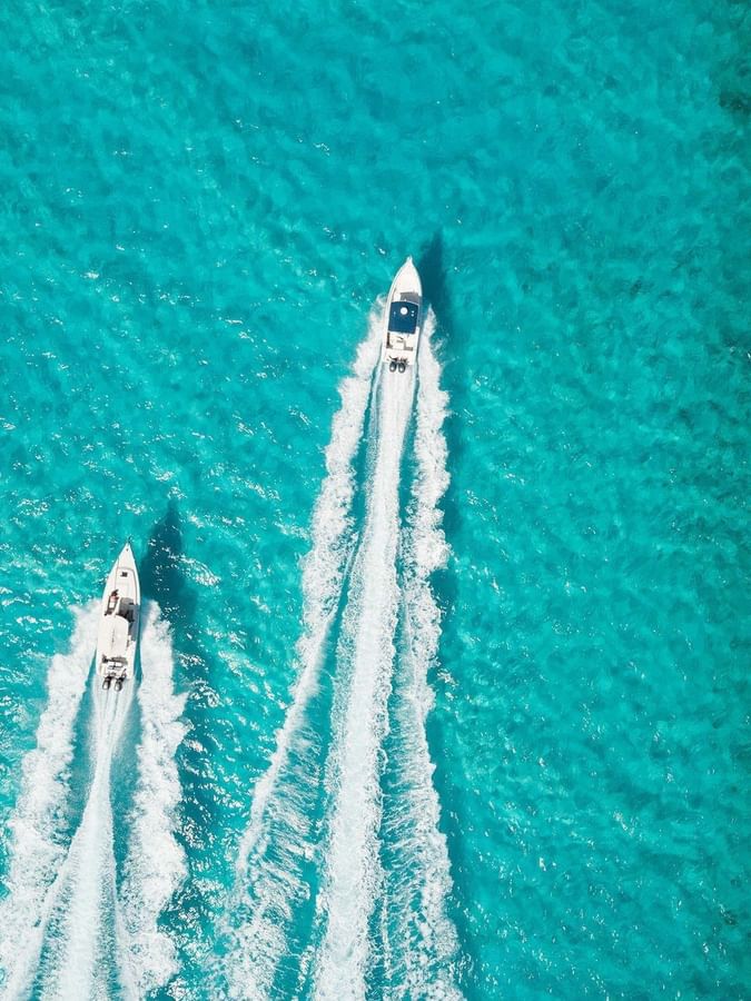 Two white boats in turquoise water near Warwick Paradise Island Bahamas