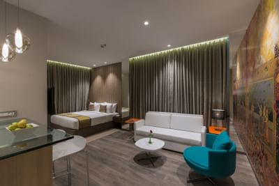 Living room & bedroom in Deluxe Studio Room at Eastin Residences Vadodara