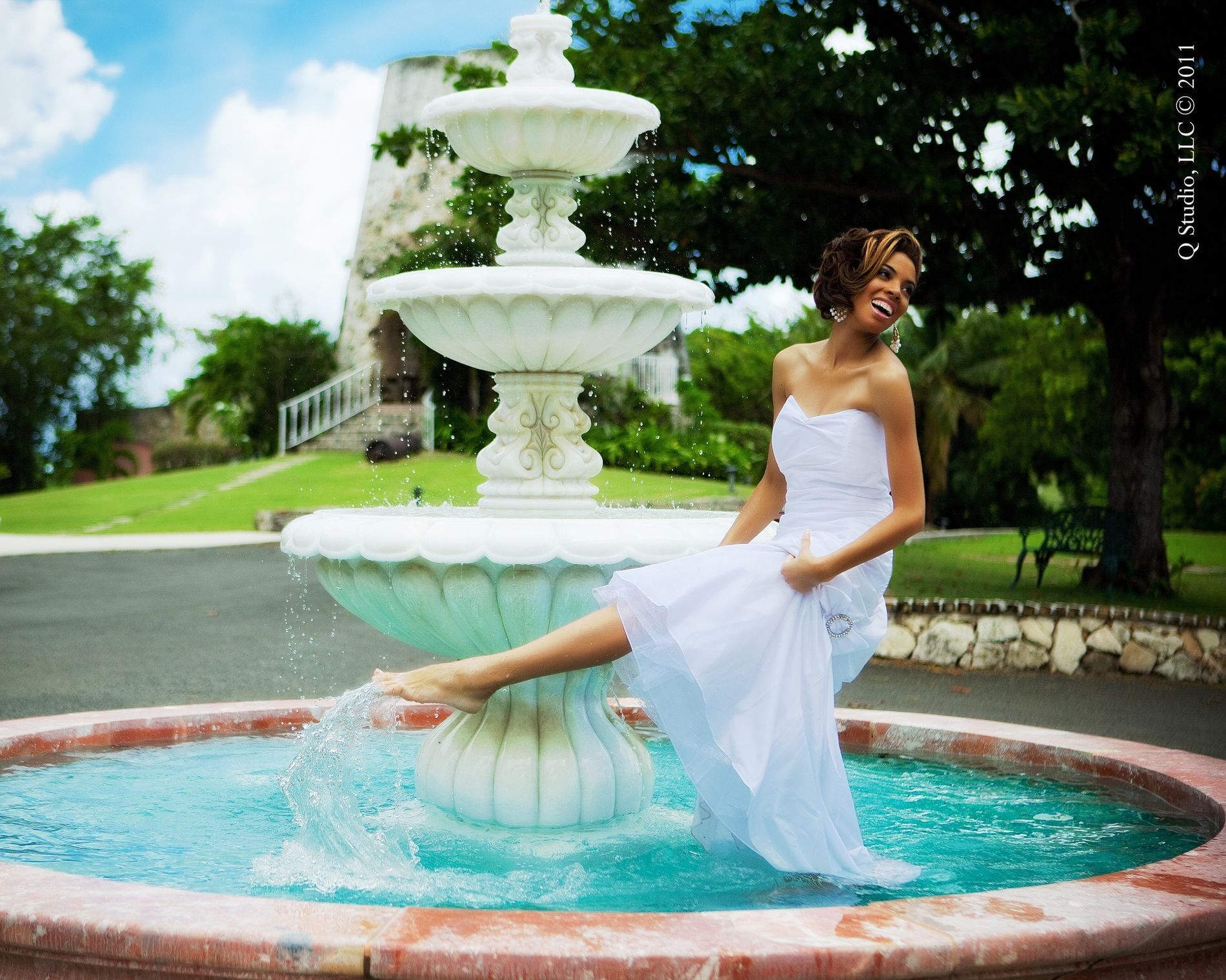Bride splashing water in the fountain at The Buccaneer Resort St. Croix