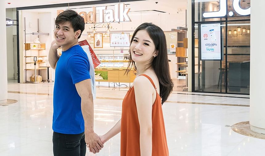 Happy couple posing inside Chadstone Mall near LK Cikarang Hotel & Residences