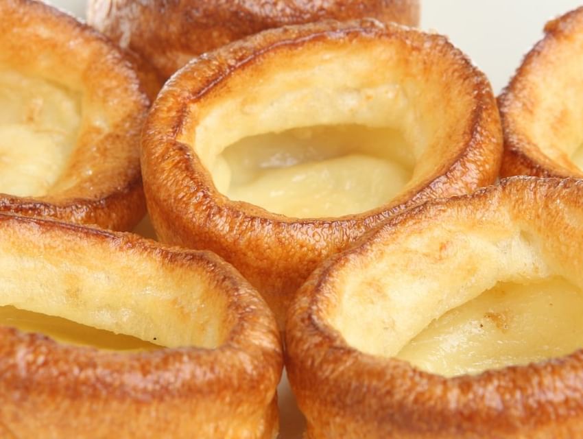 Close-up of light brown, hollow Yorkshire puddings with slightly crispy edges served in Tudors Restaurant at Marygreen Manor