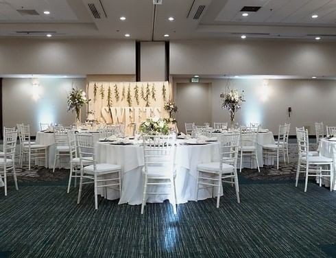 Tables & chairs arranged for a wedding in a hall at Grove Hotel