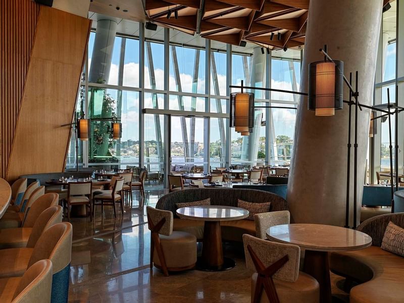 Modern restaurant interior of Nobu with large windows and wooden ceiling at Crown Hotels