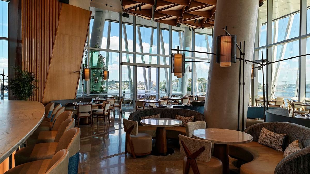 Modern restaurant interior of Nobu with large windows and wooden ceiling at Crown Hotels