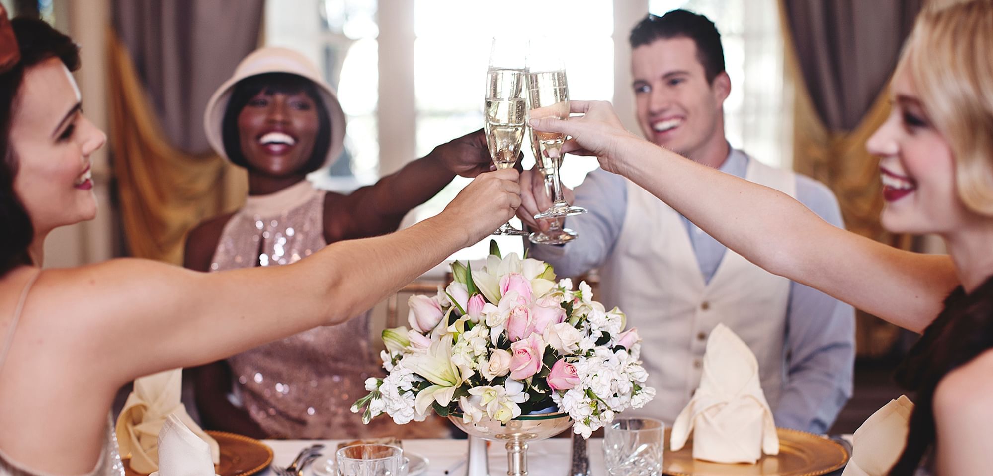 People toasting glasses at a wedding in Warwick Dallas Ballroom