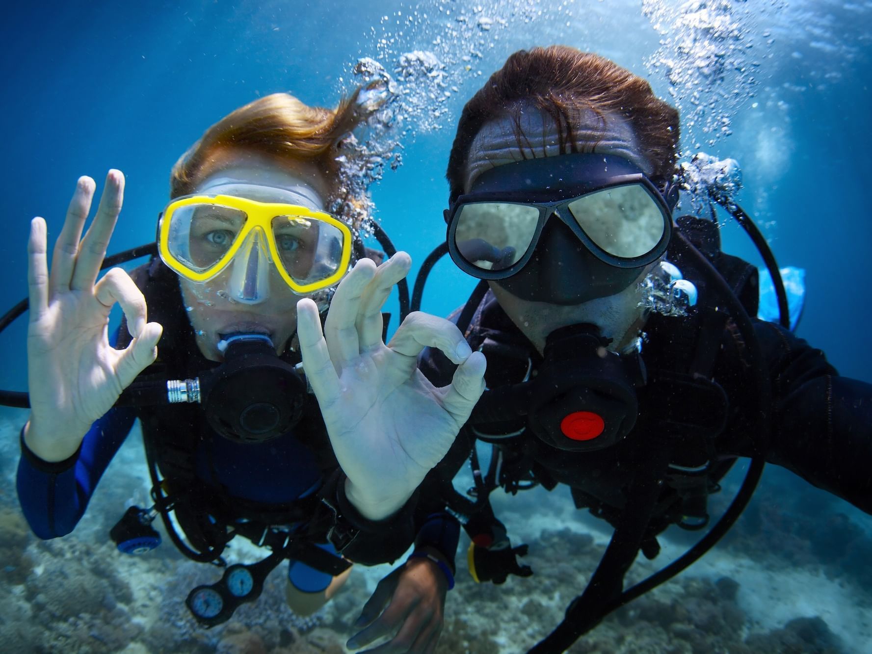 Men Posing while scuba diving at Daydream Island Resort