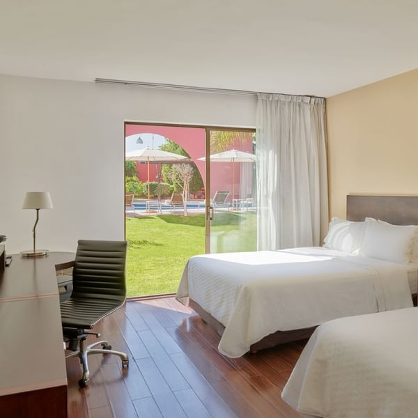 Twin beds with furniture in Superior Double room at Fiesta Inn