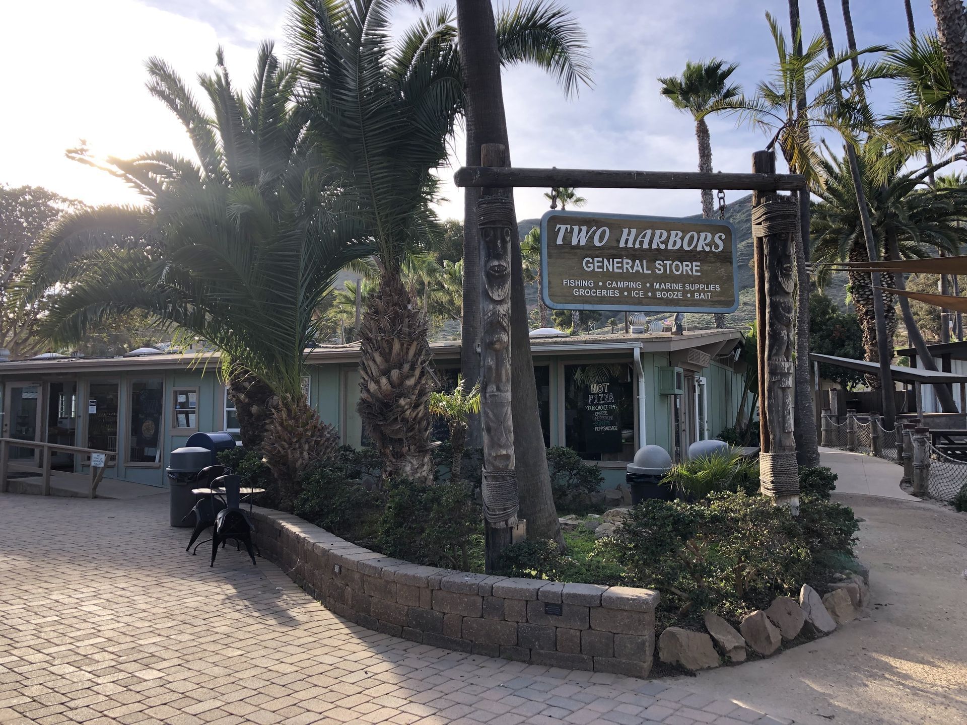 Exterior of Two Harbors General Store with palm trees and a rustic sign near Catalina Island Company