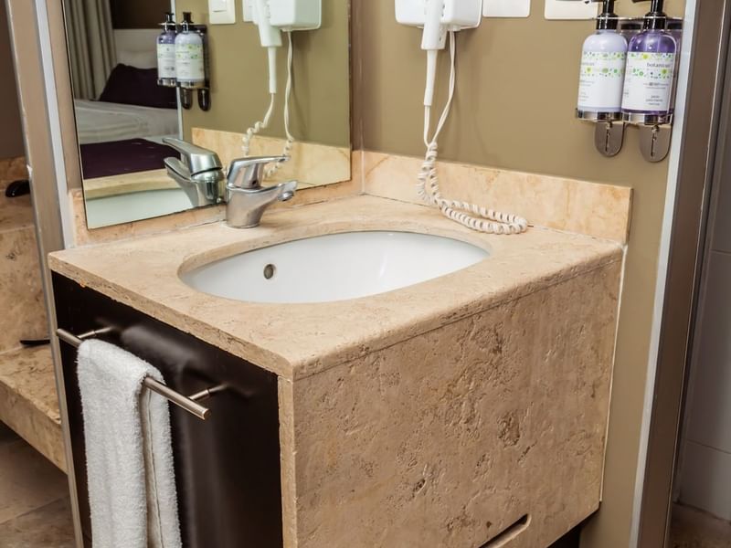 Bathroom vanity, washbasin, hairdryer, soap dispensers & mirror in Deluxe Room, 2 Double at Gamma Hotels