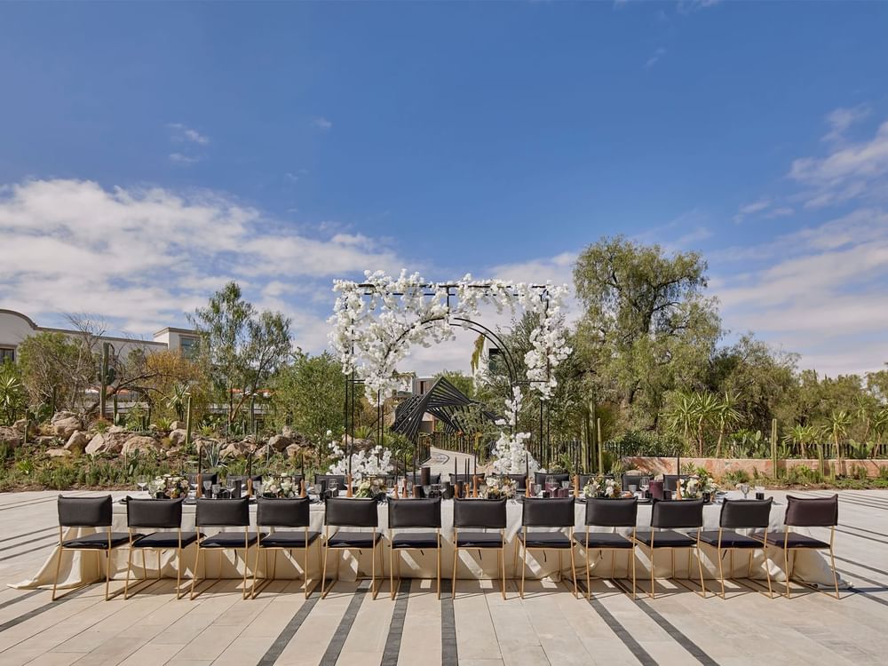 Outdoor royal banquet table & flower arch in the Garden at Live Aqua Resorts and Residence Club