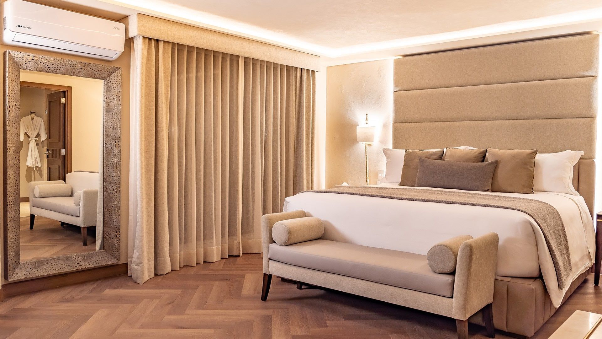 King Governor Suite with a king bed, tan curtains, and a decorative textured mirror at Quinta Real Puebla