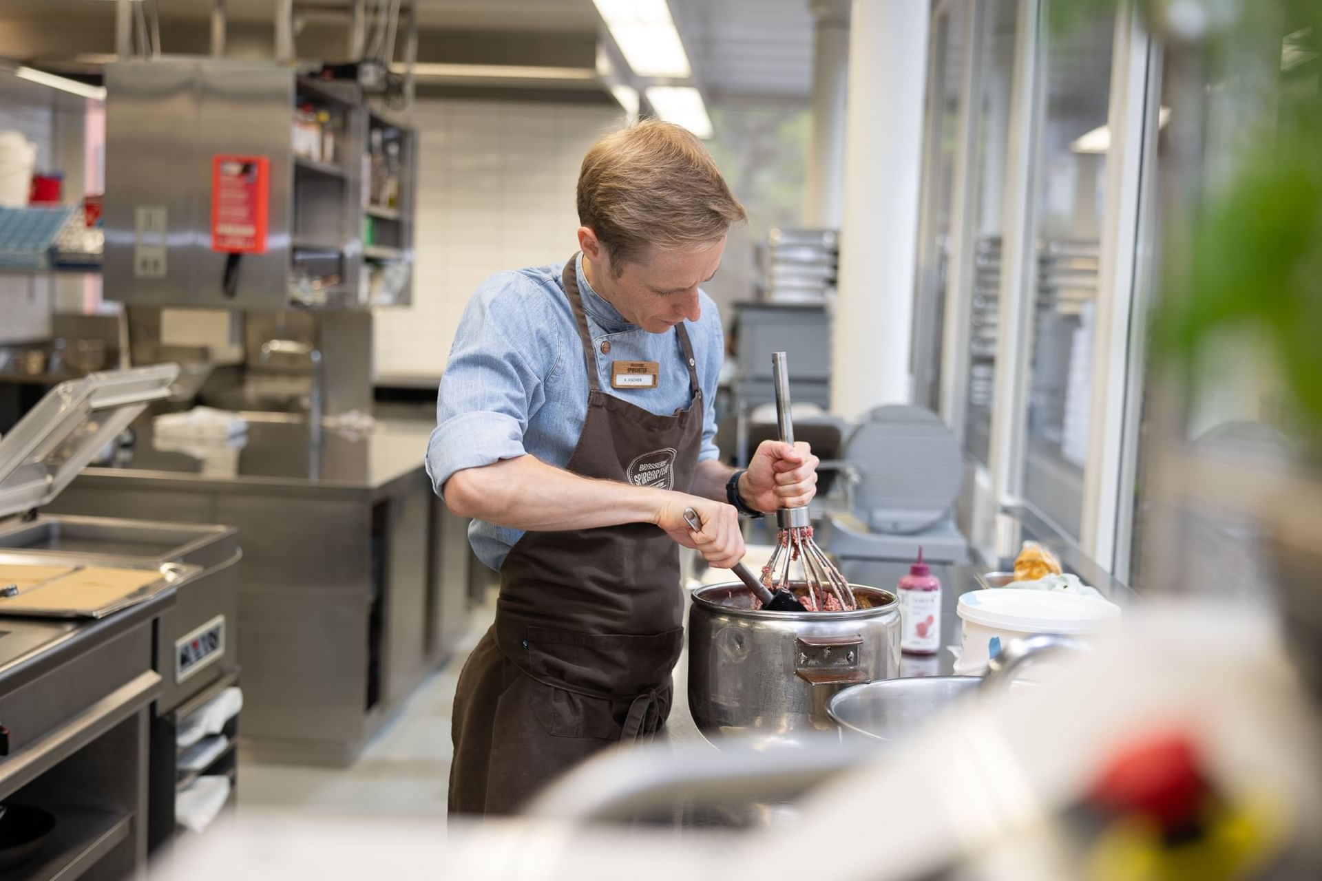 Chef making food in the kitchen area at Best Western Spirgarten
