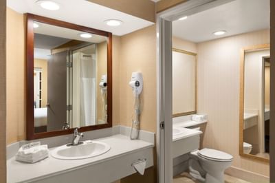Bathroom with vanity & lavatory at Anaheim Portofino Inn, an affordable hotel across from Disneyland with family suites