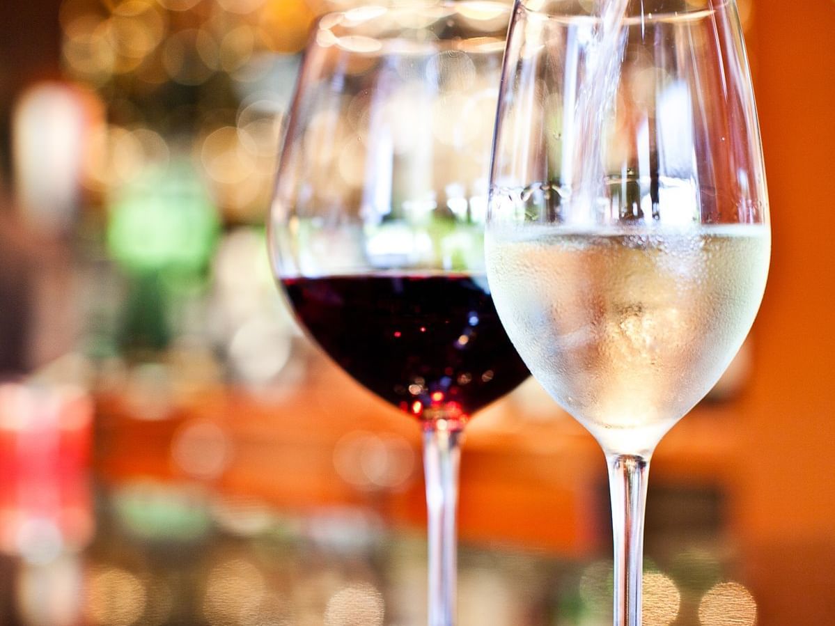 Close-up of two glasses of wine served on The Bar & Lounge counter at The Umstead Hotel and Spa