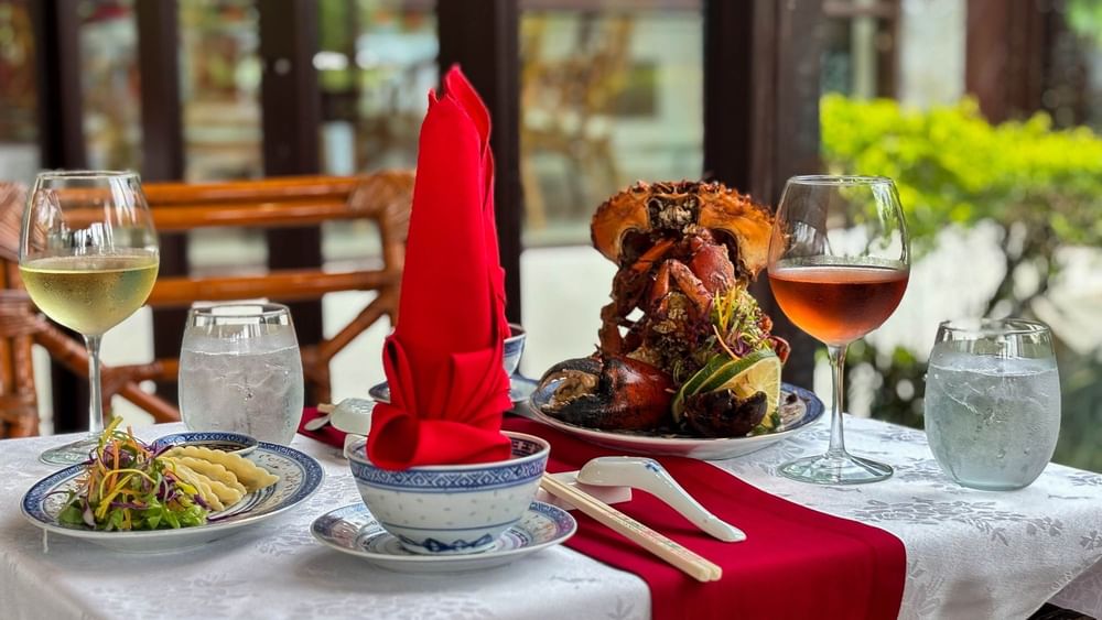 Elegant dining setup with seafood and wine at Bamboo Terrace, The Naviti Resort - Fiji, Korolevu.