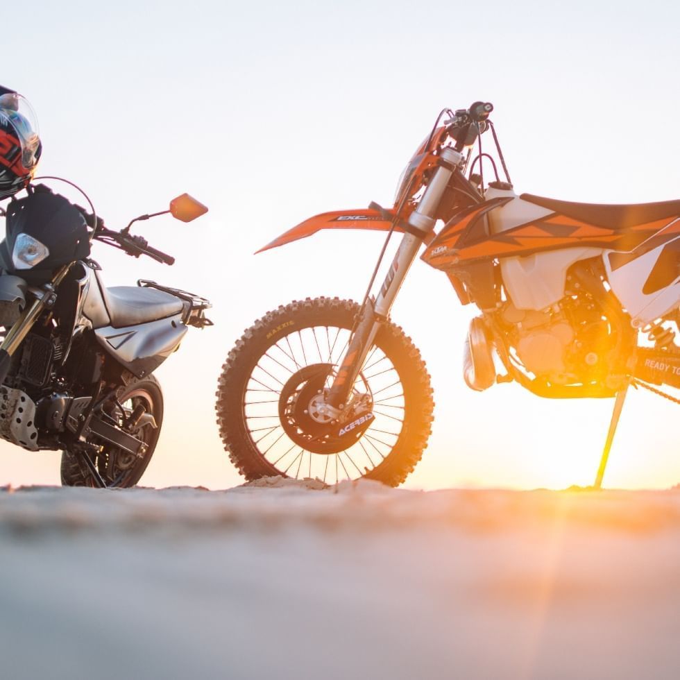 Two motorcycles side by side at sunset near Falkensteiner Hotel Schladming