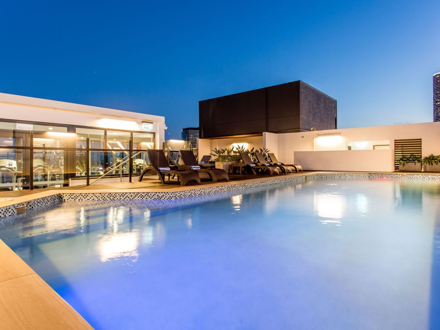 Rooftop pool with lounger at Grand Chancellor Brisbane