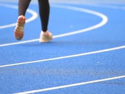 People running on the track at National Stadium near Courtleigh