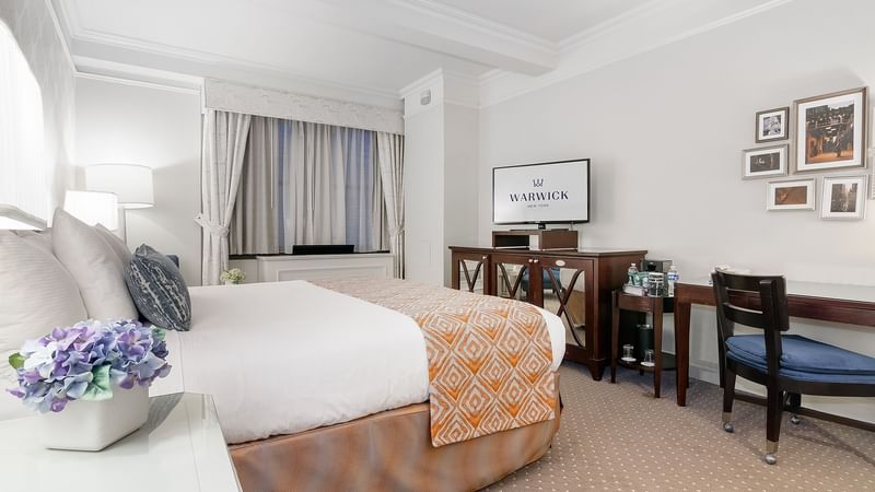 TV & work desk facing the bed in Premier Room at Warwick New York
