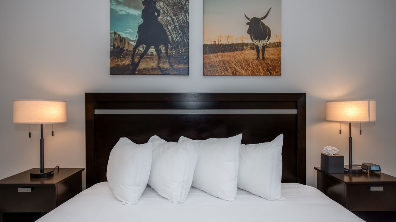 King bed at Coast Innisfail Hotel with bedside lamps