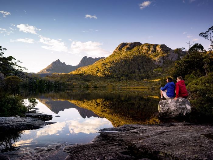 Couple sitting near Wombat Pool at Cradle Mountain Hotel 