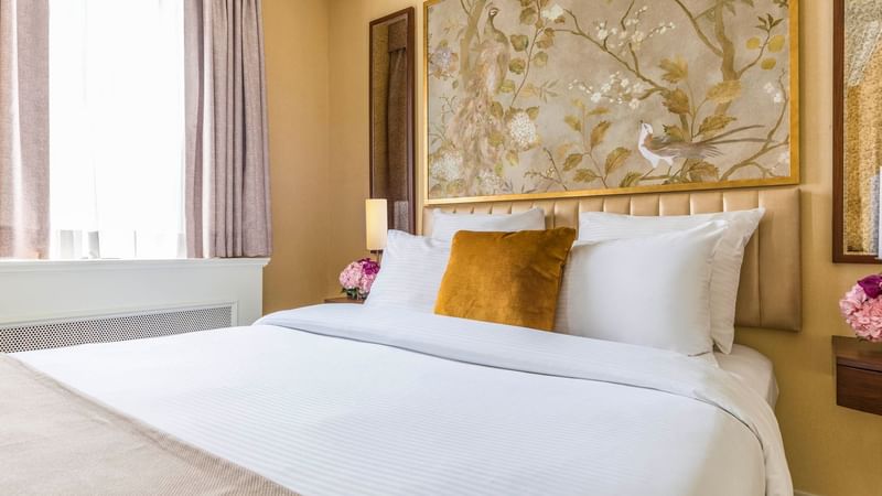 Tufted bed by the window in Queen Room at Warwick Allerton - Chicago