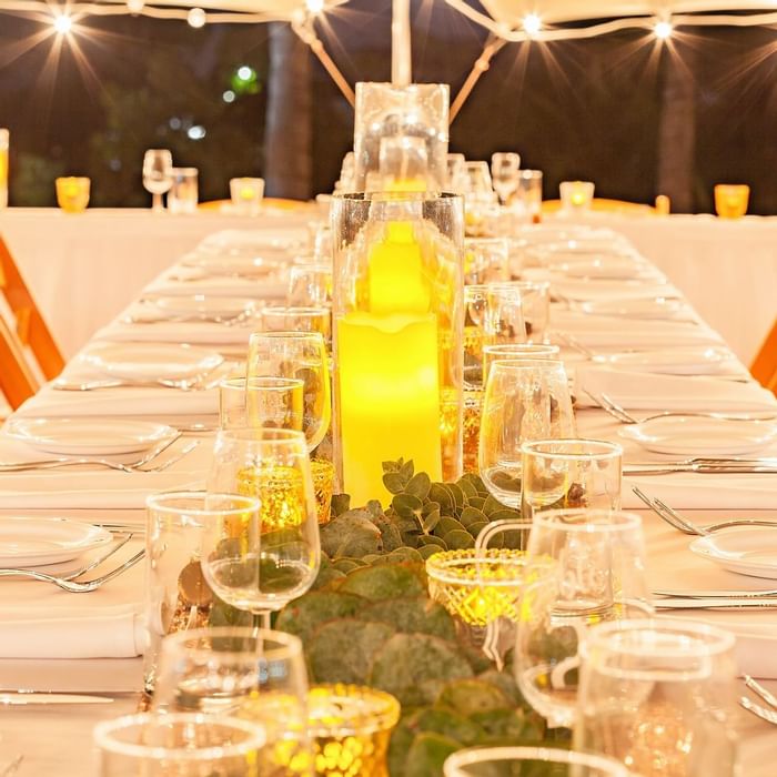 Well set dinner table under soft lights featuring candles, glassware, and greenery at Mercure Hotel Townsville