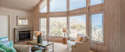 Livingroom area with a fireplace overlooking the sea at Catalina Island Company