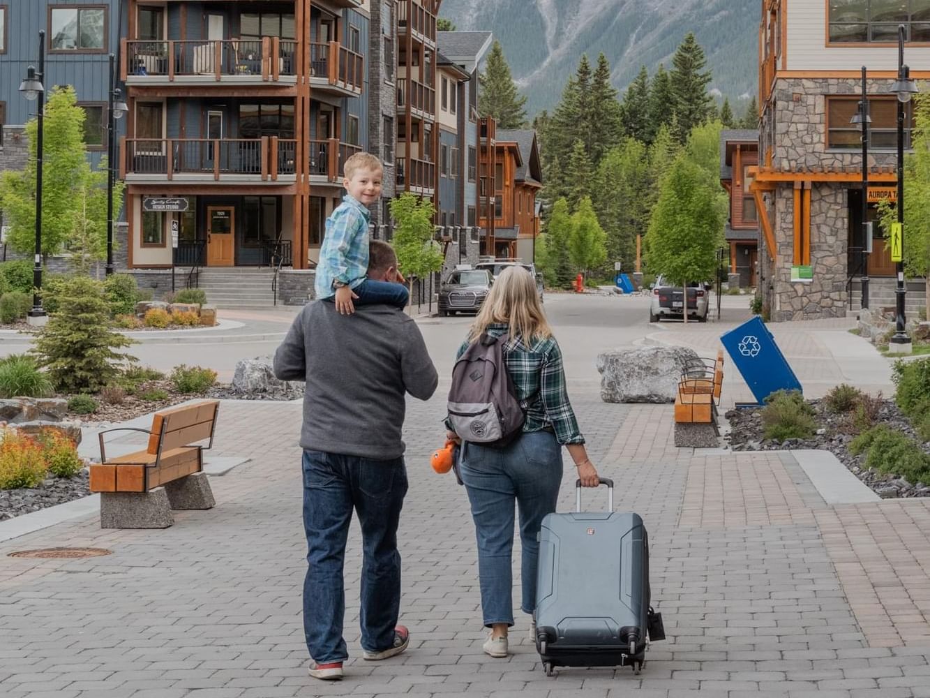 Family walking on a paved path to Spring Creek Vacations, one of the cheap hotels in Canmore