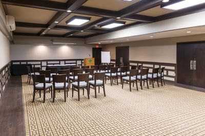 Rows of chairs face a podium, set up for a presentation, perfect for any upcoming Charlottetown conference at Rodd Royalty