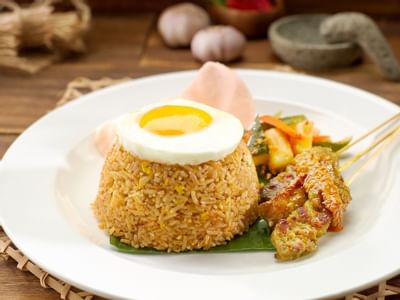 Nasi Goreng with satay on a plate in White Rose Café at York Hotel Singapore