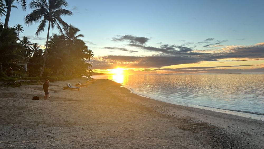 Sunset over a sand beach at Warwick Fiji Resort and Spa in Korolevu.
