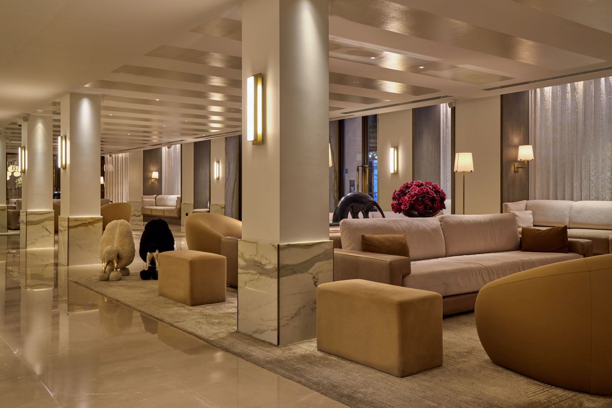 The May Fair Hotel lobby in London with elegant furniture, polished floors, and modern decor.