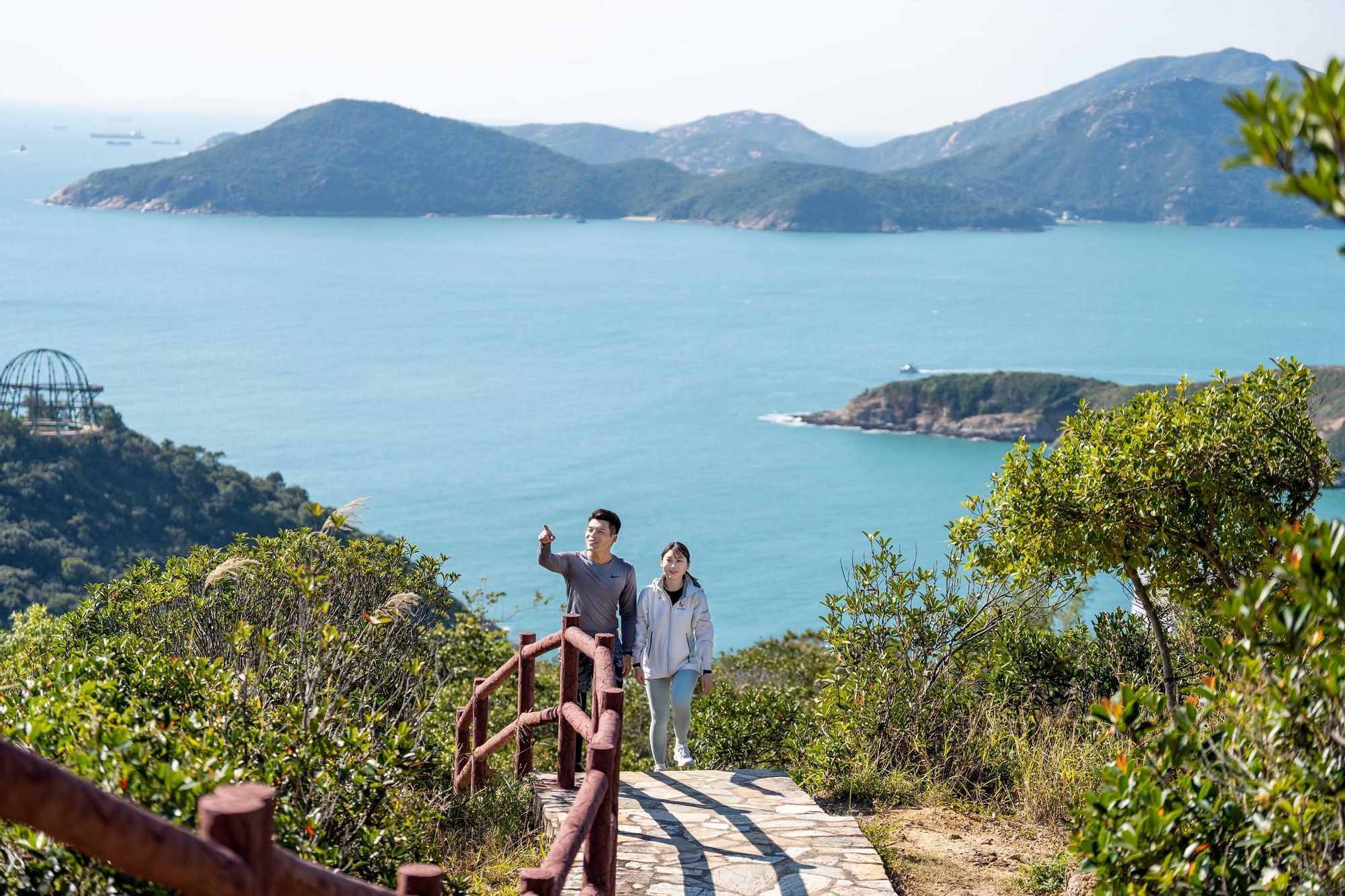Couple on a scenic trail overlooking a bay with islands near Fullerton Ocean Park Hotel Hong Kong