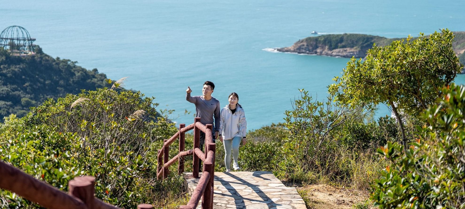 Couple on a scenic trail overlooking a bay with islands near Fullerton Ocean Park Hotel Hong Kong