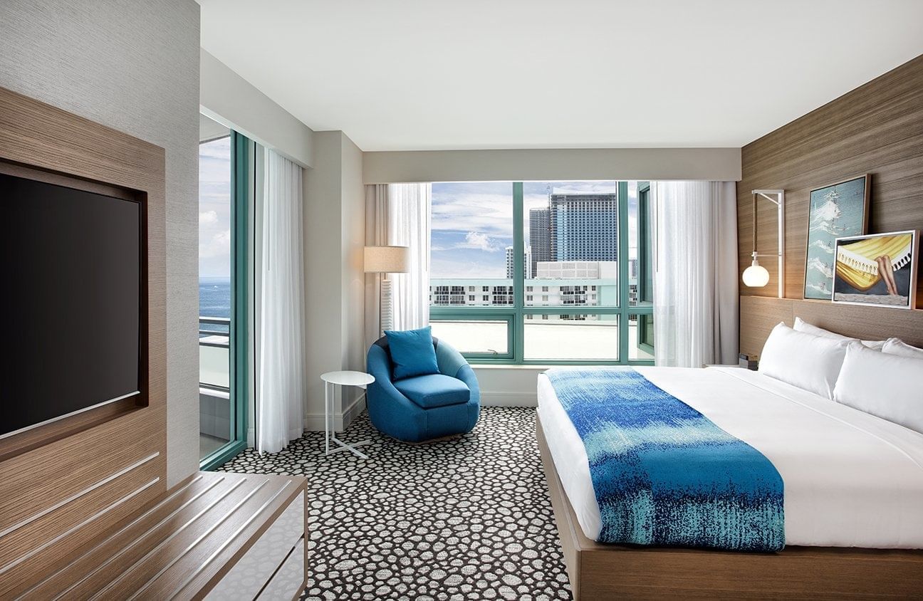 King bed, lounger & tv in Corner Suite at The Diplomat Resort