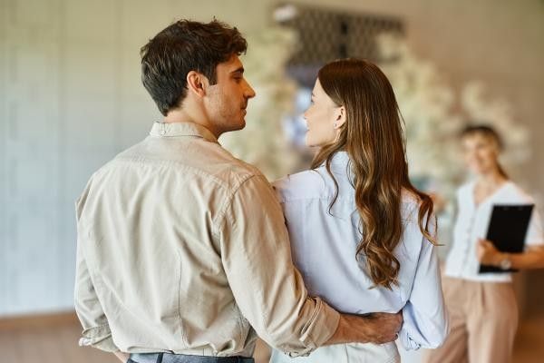 Couple attending wedding fair after they've explored top tips on how to make the most out of it
