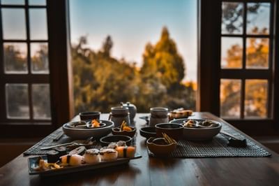 Beautifully arranged sushi dinner spread on a wooden table in Mako’s Japanese Restaurant at The Dwarika’s Hotels and Resorts