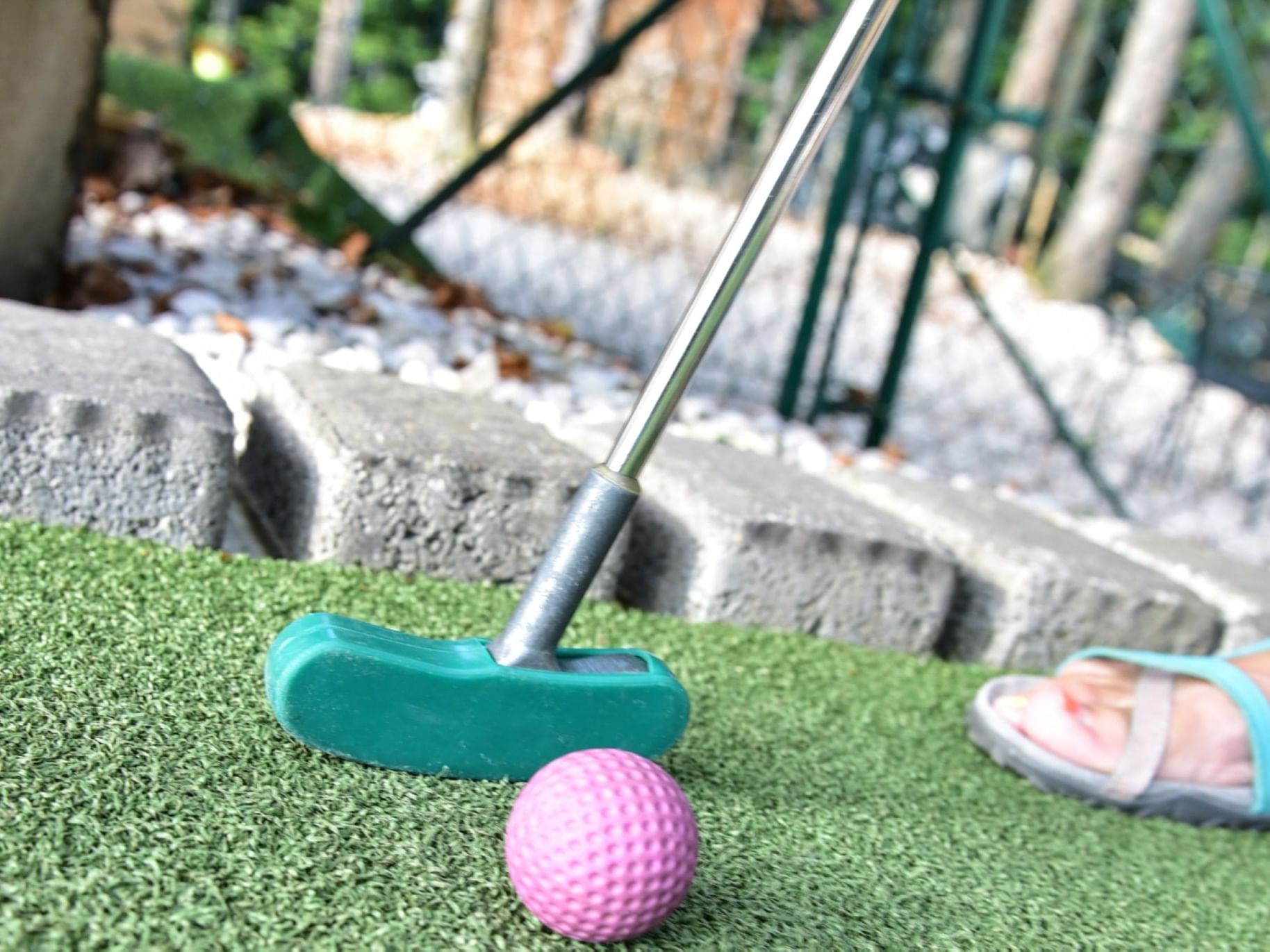A mini putter and a golf ball on the course in Wonder Mountain Fun Park near Ogunquit River Inn