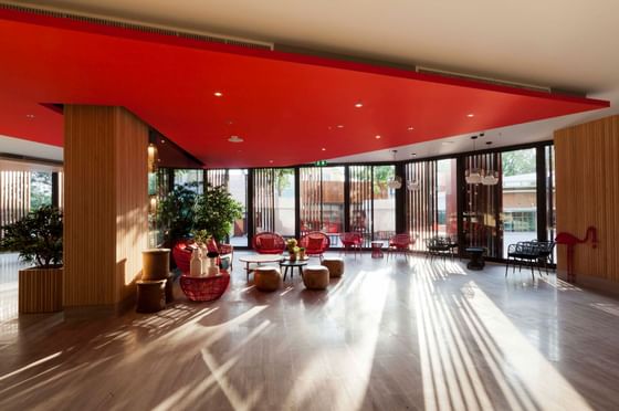 Lounge area with red cane chairs at Eastin Hotels