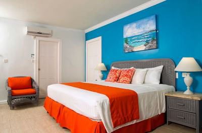 Cozy bed with side tables and sofa in Standard room at Dover Beach Hotel