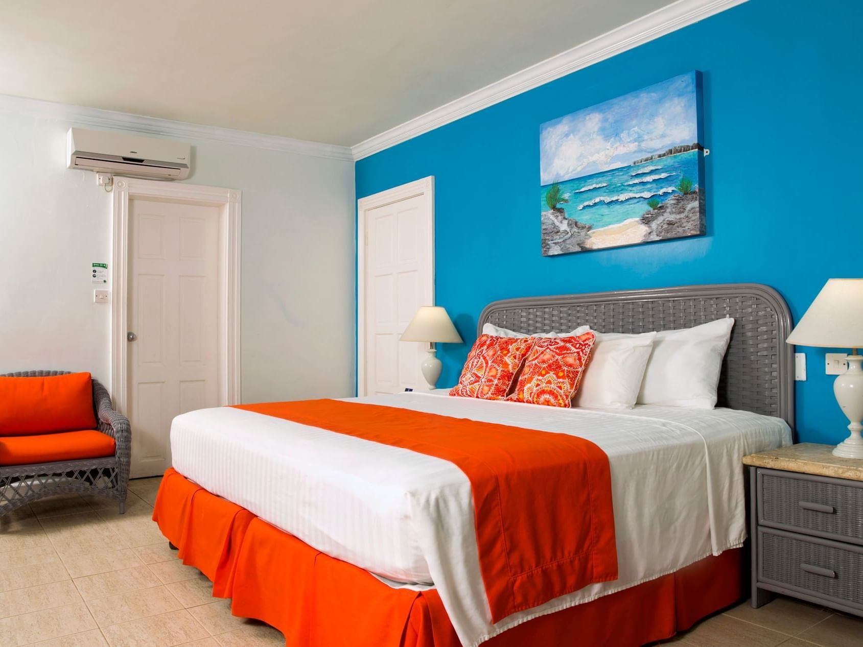 Cozy bed with side tables and sofa in Standard room at Dover Beach Hotel