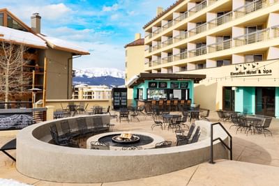 Jose Restaurant outdoor patio with tables, chairs, and fire pit at Elevation Hotel & Spa