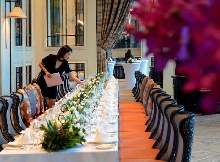 A lady setting up table for event at Fullerton Bay Singapore