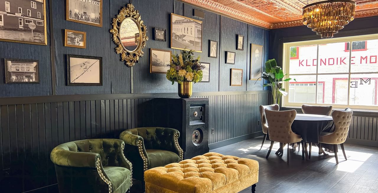 Hotel lobby with vintage photos, couches, tables, chandelier, and decoration at Midnight Sun, a Coast Hotel