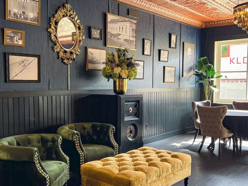 Hotel lobby with vintage photos, couches, tables, chandelier, and decoration at Midnight Sun, a Coast Hotel