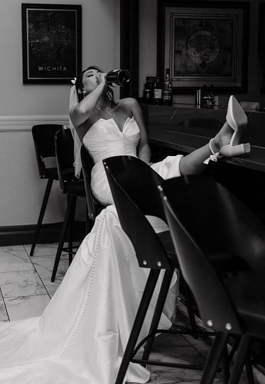 Bride drinking champagne at The 1906 Bar at Hotel at Old Town