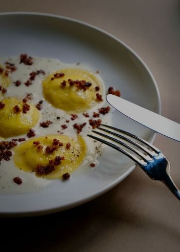 Close-up of an omelet served with a set of cutlery at Da Mariolino Restaurant