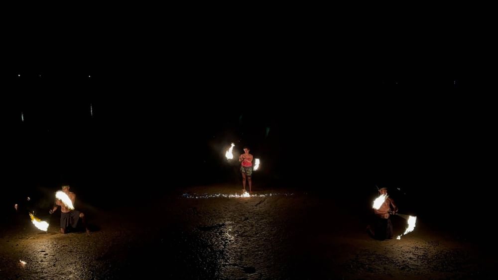 Performers engaging in a fire dance show in the dark at The Naviti Resort in Korolevu.